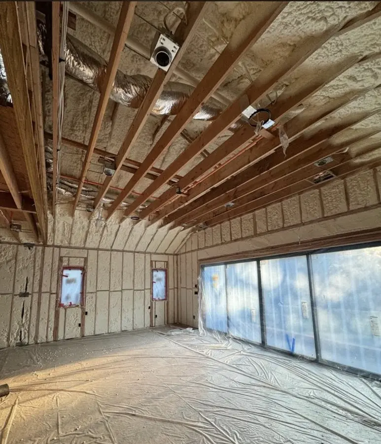 Interior walls and ceiling insulated with spray foam during new construction in El Rio